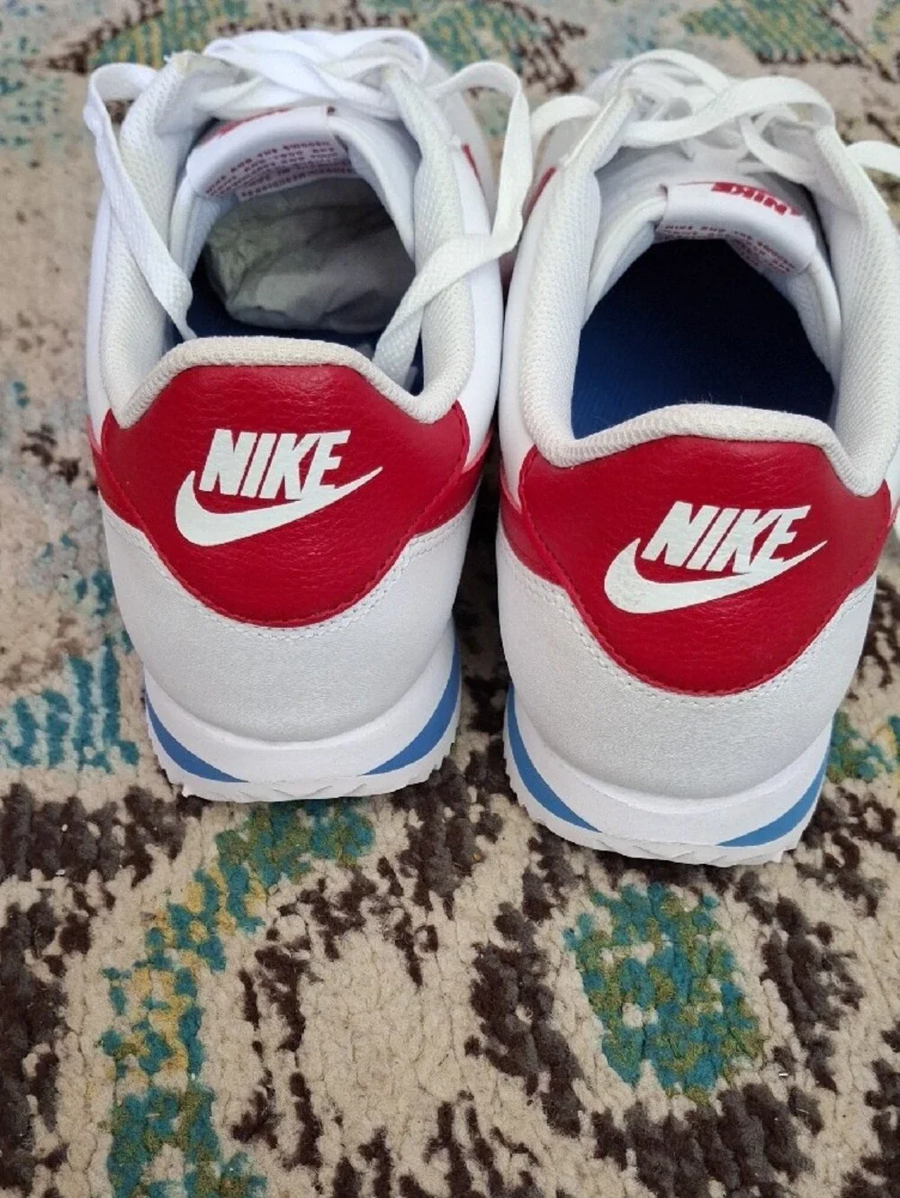 Nike White Sneakers with Red Swoosh and Blue Stripe